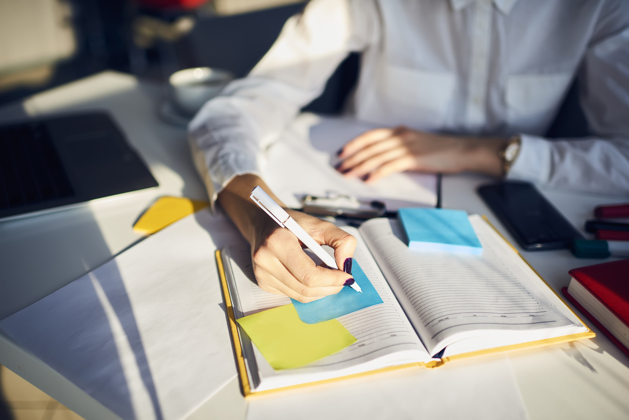 Image of female secretary planning in a diary